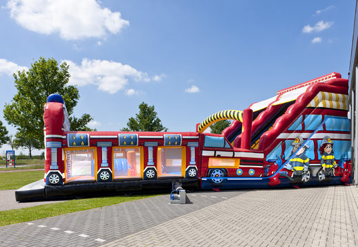 Buy an inflatable extra wide slide in the Fire Brigade World theme with 3D obstacles for children. Order inflatable slides now online at JB Inflatables America