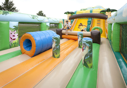 Buy a unique extra wide inflatable slide in the jungle world theme with 3D obstacles for children. Order inflatable slides now online at JB Inflatables America