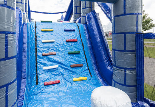 Unique 17 meter wide obstacle course in a castle theme with 7 game elements and colorful objects for kids. Buy inflatable obstacle courses online now at JB Inflatables America