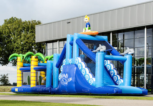 Buy a 17 meter wide inflatable obstacle course in the surf theme with 7 game elements and colorful objects for kids. Order inflatable obstacle courses now online at JB Inflatables America