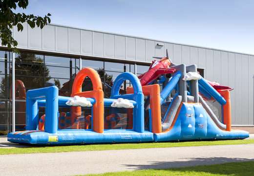 Buy a 17-meter-wide obstacle course in an airplane theme with 7 game elements and colorful objects for kids. Order inflatable obstacle courses now online at JB Inflatables America
