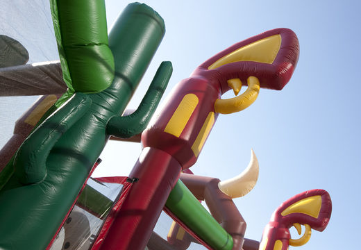 Buy a unique 17 meter wide cowboy themed obstacle course with 7 game elements and colorful objects for kids. Order inflatable obstacle courses now online at JB Inflatables America