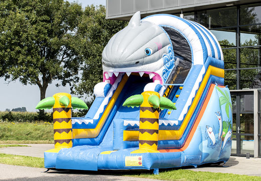 Buy Shark slide slide with the cheerful colors and nice print on the back wall. Order inflatable slides now online at JB Inflatables America