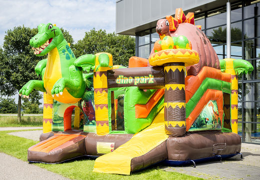 Buy medium covered inflatable multiplay bounce house in the theme dinoworld with slide for children. Order inflatable bounce houses online at JB Inflatables America