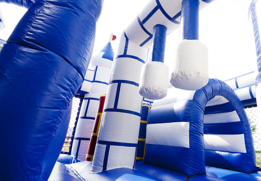 Multiplay blue and white castle bounce house with a slide and fun objects on the jumping surface for kids. Order inflatable bounce houses online at JB Inflatables America