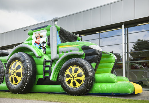 Order a 17 meter wide unique tractor themed obstacle course with 7 game elements and colorful objects for children. Buy inflatable obstacle courses online now at JB Inflatables America