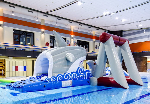 Airtight inflatable shark play island with a vine, climbing tower, round slide and obstacles for both young and old. Order inflatable water attractions now online at JB Inflatables America
