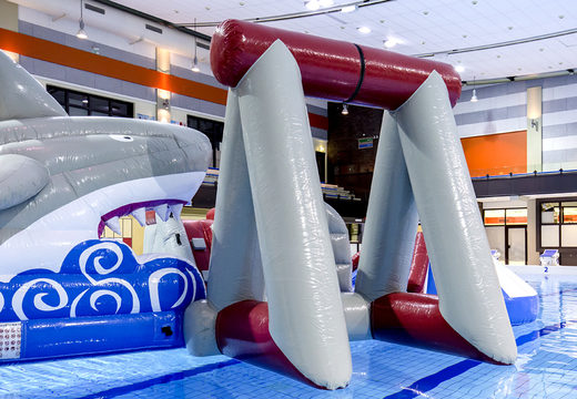 Unique airtight inflatable play island in shark theme with a liana, climbing tower, round slide and obstacles for both young and old. Buy inflatable water attractions online now at JB Inflatables America