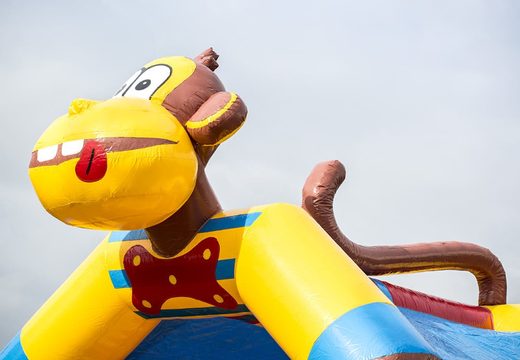 Standard bounce house in striking colors with a large 3D object of a monkey on top for sale for children. Buy indoor bounce houses online at JB Inflatables America