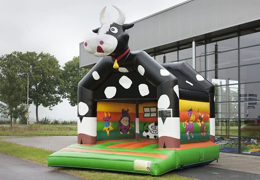 Buy a standard bounce houses for children in striking colors with a large 3D object in the shape of a cow on top. Order bounce houses online at JB Inflatables America