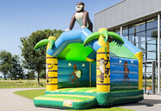 Buy a standard jungle bounce houses for children in striking colors with a large 3D object in the shape of a gorilla on the top. Order bounce houses online at JB Inflatables America