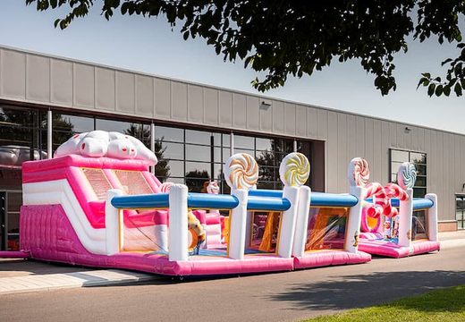 Candyworld themed inflatable bounce house with multiple slides and all sorts of fun obstacles with themed prints for kids. Order bounce houses online at JB Inflatables America