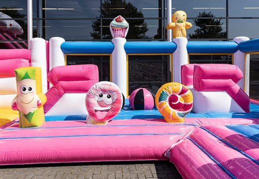 Buy an inflatable Candyworld bounce house with multiple slides and all kinds of fun obstacles with candyland prints for kids. Order bounce houses online at JB Inflatables America