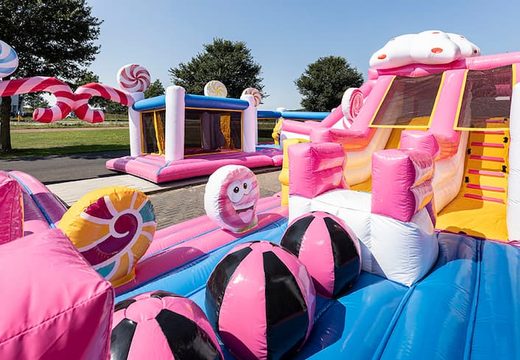 World Candyland bounce house with multiple slides and all sorts of obstacles with themed prints for kids. Buy bounce houses online at JB Inflatables America