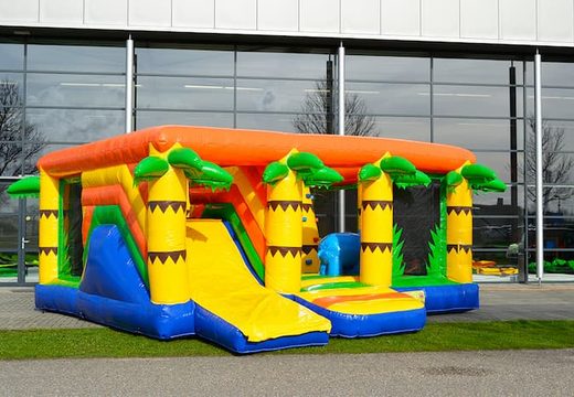 Buy an indoor multiplay jungle bounce house in a limited height of 2.74 meters and with a slide for children. Order bounce houses online at JB Inflatables America 