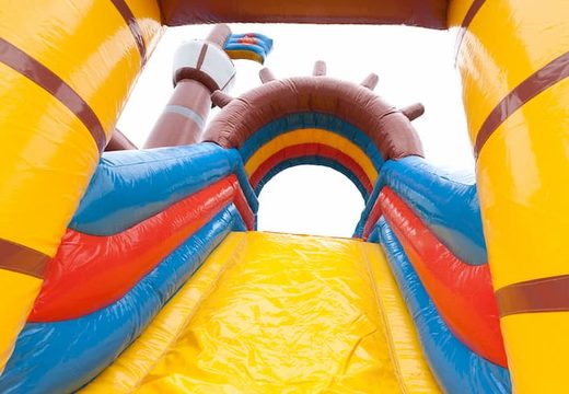 Buy pirate boat bounce house in a unique design with two entrances, a slide in the middle and 3D objects for kids. Order bounce houses online at JB Inflatables America 