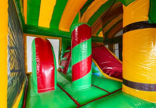 Order a crocodile bounce house in a unique design with two entrances, a slide in the middle and 3D objects for kids. Buy bounce houses online at JB Inflatables America 