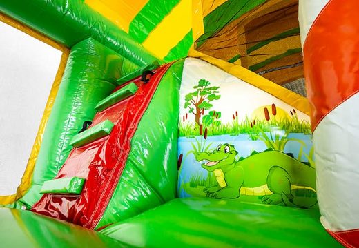 Buy Jungleworld bouncer in a unique design with two entrances, a slide in the middle and 3D objects for kids. Order bouncers online at JB Inflatables America 