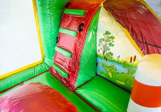 Inflatable multiplay Jungleworld bouncer with a slide in the middle and 3D objects for children. Order bouncers online at JB Inflatables America 