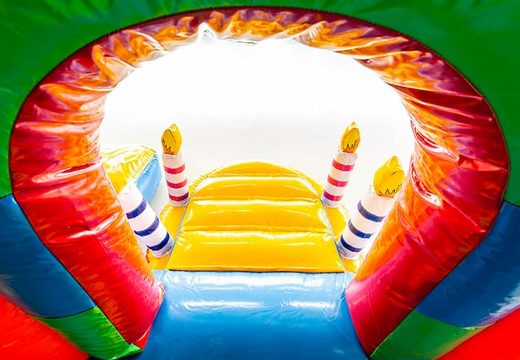 Party themed bounce house with a slide and 3D objects for kids. Buy bounce houses online at JB Inflatables America 