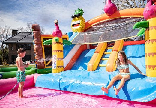 Order a bouncer with water slide for your garden in the flamingo theme for children. Buy bouncers online at JB Inflatables America