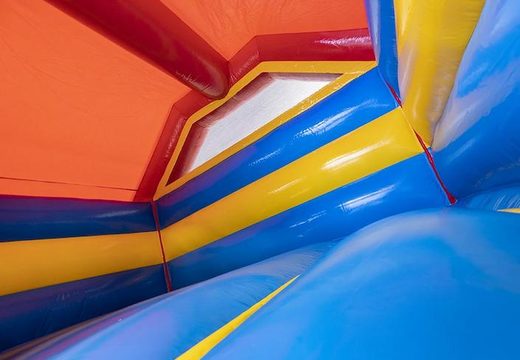 Order an inflatable bouncy castle with slide in a rollercoaster theme for children