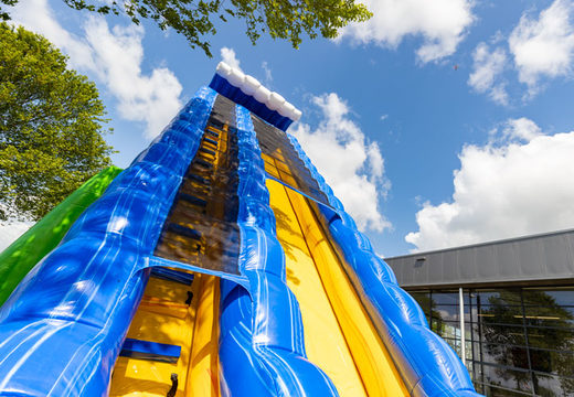Climbing on bouncy castle with slide and pool