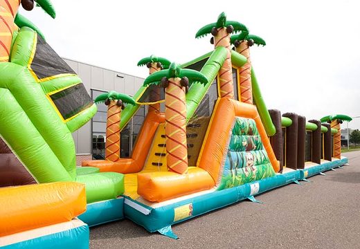 Palm trees and obstacles on striking bouncy castle