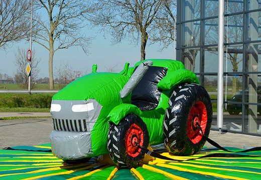 Inflatable bouncer with rodeo tractor