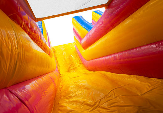 Yellow slide with pink, yellow, blue multiplay 4 in 1 bouncy castle for sale at JB